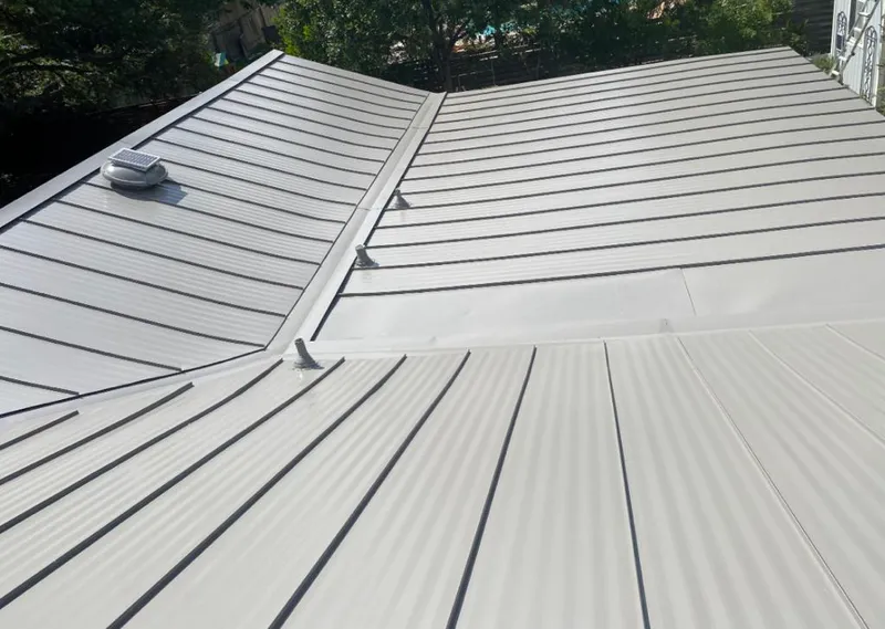 Solar attic fan installed on a metal roof for Roof Ventilation in Oradell